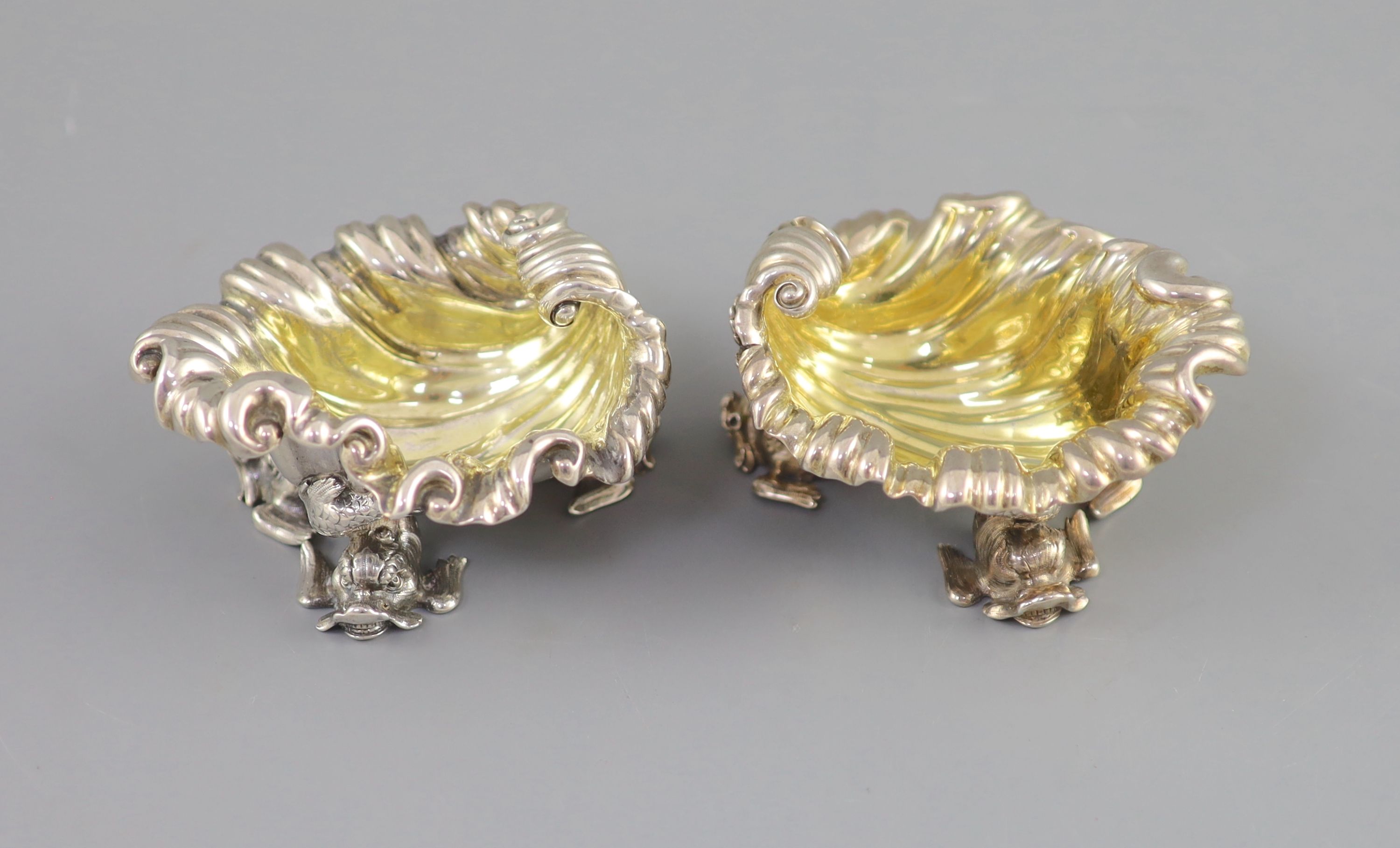 A pair of George IV silver shell shaped salts, by Paul Storr